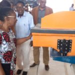 Attendees look at the Sanku dosifier up close