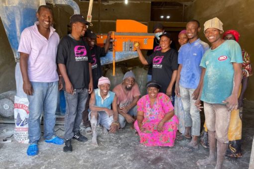 A group of millers around a dosifier. Photo Credit: Sanku